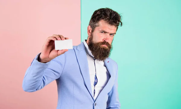 Bearded hipster serious face show card. Banking services for business. Business card design. Card copy space professional occupation position. Feel free contact me. Businessman hold blank card