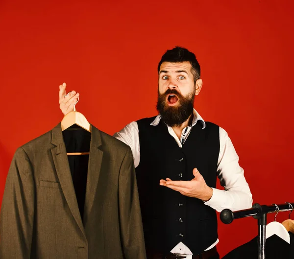 Designer and suit on clothes hanger. Man with beard