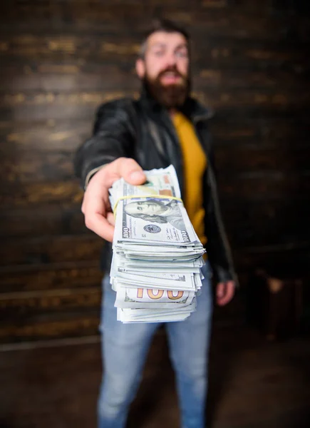 Mafia business. Man brutal bearded hipster wear leather jacket and hold cash money. Illegal profit and black cash. Guy mafia dealer with cash profit. Man give cash money bribe. Richness and wellbeing — Stock Photo, Image