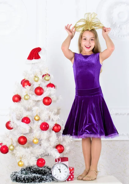 Very special time of year. Kid happy because holiday season arrive. Family holiday concept. Girl velvet dress feel festive near christmas tree. Make this day best holiday ever. Winter holiday concept