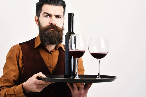 Man with beard holds alcohol on white background