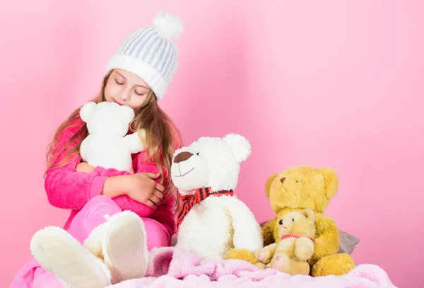 Why kids love stuffed animals. Kid little girl play with soft toy teddy bear on pink background. Toy every child dreaming. Happy childhood concept. Child small girl playful hold teddy bear plush toy