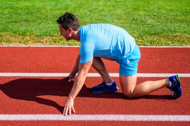 Zafer için çaba. Runner gitmeye hazır. Yetişkin runner yarış Stadyumu'nda hazırlayın. Nasıl yayınlanmaya başlaması. Profesyonel atlet spor ipuçları. Adam atlet runner standı düşük başlangıç pozisyonu stadyum yolu