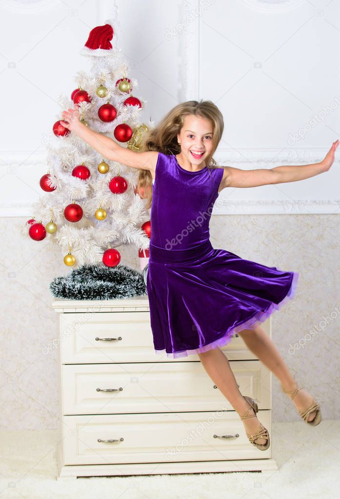 Girl in dress jumping. It is christmas. Day we have waited for all year finally here. Girl excited about christmas jump mid air. Celebrate christmas concept. Child emotional cant stop her feelings