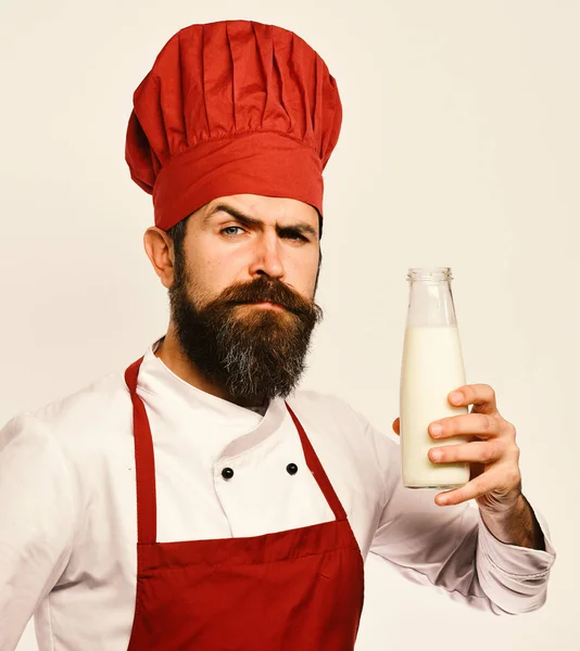 Man met baard houdt fles melk op witte achtergrond. — Stockfoto