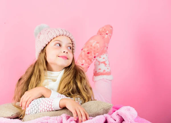 Girl long hair dream pink background. Kid dreamy face wear knitted accessory. Kid girl wear cute knitted fashionable hat and scarf accessory. Winter fashion accessory. Winter accessory concept