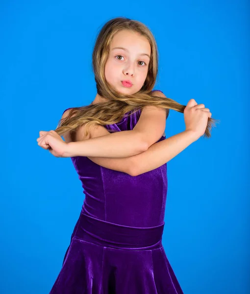 How to make tidy hairstyle for kid. Things you need know about ballroom dance hairstyle. Ballroom latin dance hairstyles. Kid girl with long hair wear dress on blue background. Hairstyle for dancer