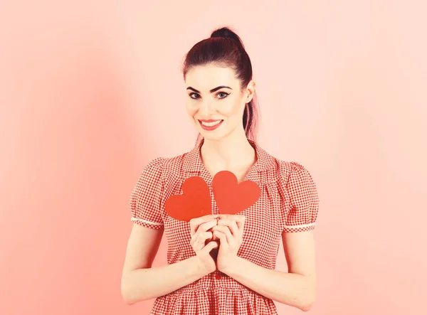 Citas, coquetear, romance, emociones, concepto sexy. Chica con la cara alegre, maquillaje y corazones rojos. Mujer en vestido elegante tiene símbolos románticos. Lleno de amor. Chica feliz sonríe con corazones de San Valentín —  Fotos de Stock