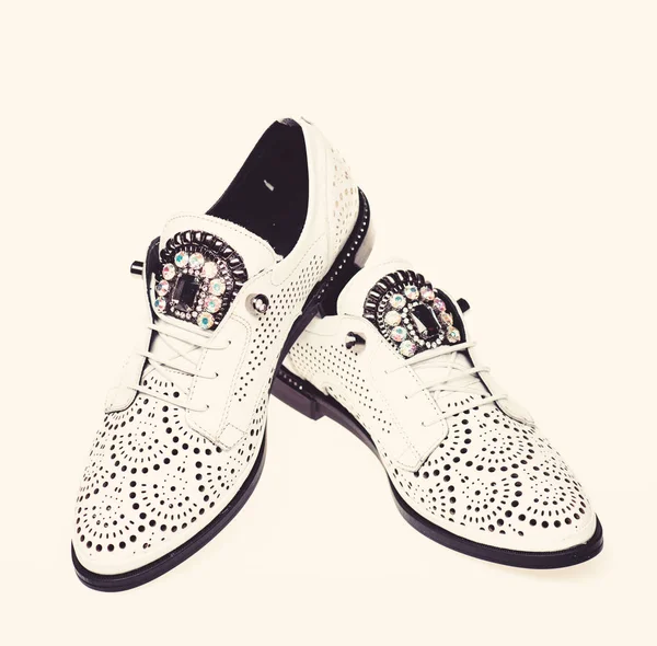 Pair of fashionable comfortable oxfords shoes. Female footwear concept. Footwear for women on flat sole with perforation and rhinestones. Shoes made out of white leather on white background, isolated — Stock Photo, Image