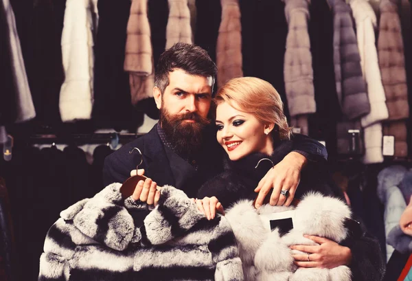 Woman with smiling face in fur coat with bearded man