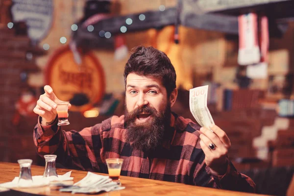 Guy spend leisure in bar drinking cocktail, defocused background.