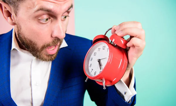 Time management skills. How much time left till deadline. Time to work. Man bearded surprised businessman hold clock. Stress concept. Mature man with wondering. Businessman has lack of time