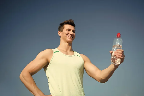 Homem feliz com garrafa de água em mãos musculares — Fotografia de Stock