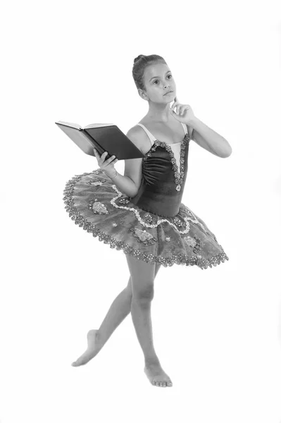 Girl ballerina dancing while read book. Ballet career issues. Depriving children ballerina. Most of time child dancer spend in gym training and practicing performance. No time for school studying — Stock Photo, Image