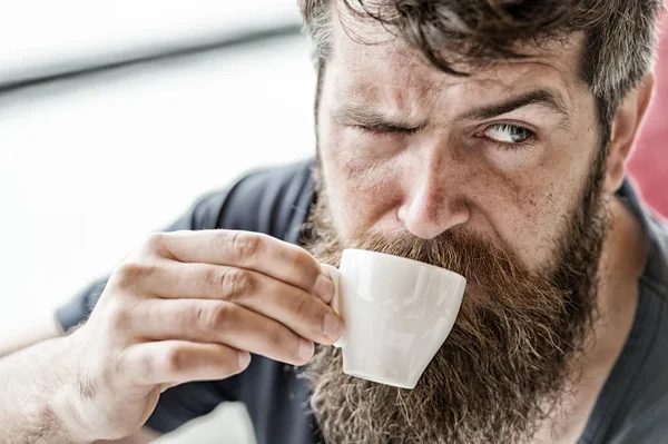 Coffee break concept. Guy relaxing with espresso coffee. Enjoy hot drink. Hipster drinking coffee outdoor. Man with beard and mustache and cup of coffee. Bearded guy relaxing at cafe terrace