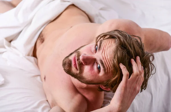 How to get up in morning feeling fresh. Enjoy every morning. Tips on how to wake up feeling fresh and energetic. Morning routine tips to feel good all day. Man handsome guy lay in bed in morning — Stock Photo, Image