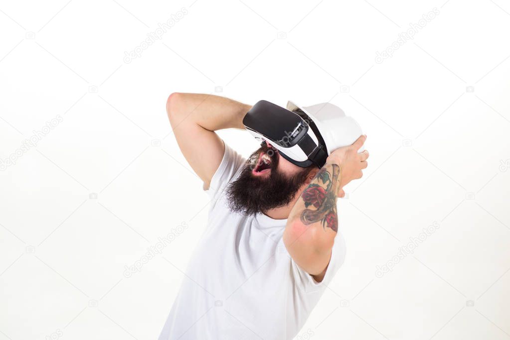 The man with glasses of virtual reality. Portrait of young man wearing vr goggles, experiencing virtual reality using 3d headset. Amazed young man touching the air during the VR experience.