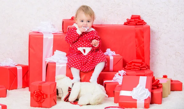 Little baby girl play near pile of gift boxes. Family holiday. Things to do with toddlers at christmas. Christmas gifts for toddler. Celebrate first christmas. Gifts for child first christmas