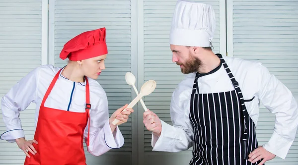 Culinary battle of two chefs. Couple compete in culinary arts. Kitchen rules. Culinary battle concept. Woman and bearded man culinary show competitors. Who cook better. Ultimate cooking challenge — Stock Photo, Image