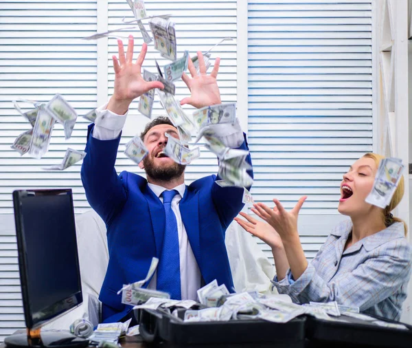 Businessman with money on office room. Happy and excited man sitting at table covered with money and rejoices with girl secretary. Chek out my profit this month. — Stock Photo, Image