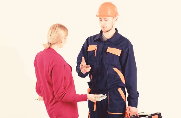 Woman client pay to man in helmet, isolated on white