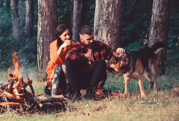 Family pet concept. Woman, man and dog on vacation,