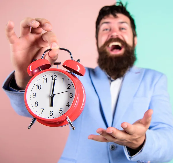 Man bearded happy cheerful businessman hold alarm clock. Timely concept. Hipster happy working day is over. Businessman finished on time. Time management skills. Best time of day. Just in time
