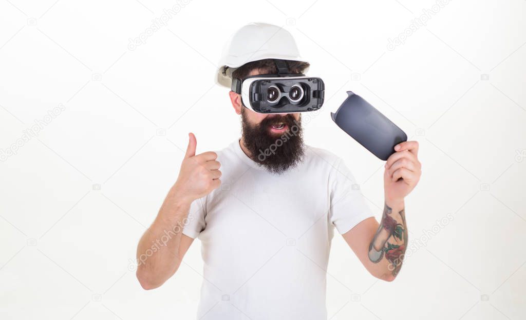 Person with virtual reality helmet isolated on white background. Portrait of bearded male in a white T-shirt with virtual reality glasses on his head isolated on white background. VR.