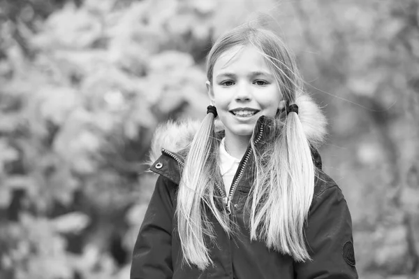 Niña caminar día de otoño. Niño rubio pelo largo caminando en chaqueta caliente al aire libre. Chica feliz en abrigo rojo disfrutar del parque natural de otoño. Los niños usan abrigo de moda con capucha. Ropa de otoño y concepto de moda — Foto de Stock