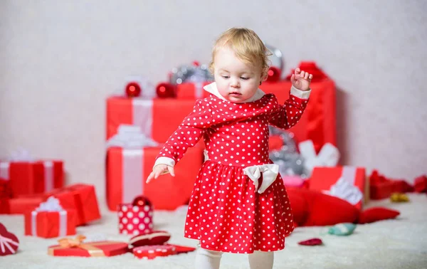 Things to do with toddlers at christmas. Little baby girl play near pile of gift boxes. Family holiday. Christmas activities for toddlers. Christmas miracle concept. Gifts for child first christmas
