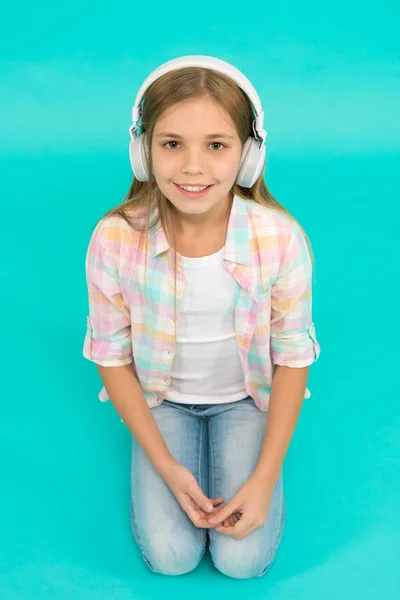 Listen to music. Beauty and fashion. small kid listen ebook, education. Childhood happiness. Mp3 player. childrens day. Audio technology. small girl child in headphones. Enjoying music