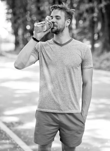 Tiempo de relax. tiempo para relajarse. tiempo de relax de deportista saludable. hombre atlético tiene tiempo de relax en el bosque y beber agua . — Foto de Stock