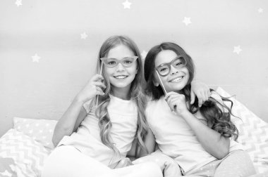 Doğum günü kızı. Çocuk palyaçoluk photo booth sahne ile poz. Pijama partisi yatak odasında. Arkadaşlar sevimli ve neşeli gözlük aksesuarları ile poz. Kız arkadaşlar eğlenmeye pijama partisi