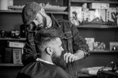 Sakal hipster istemcisinin damat ile meşgul berber, güzellik arka plan sağlar. Sakallı hippi şık berber dükkanı olarak profesyonel kuaför tarafından hizmet veren cape kaplı. Damat kavramı