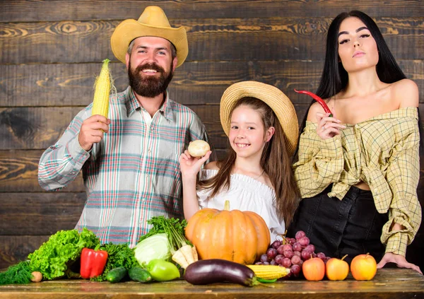 Family father farmer mother gardener with daughter near harvest. Countryside family lifestyle. Farm market with fall harvest. Family farm festival concept. Man bearded rustic farmer with kid and wife