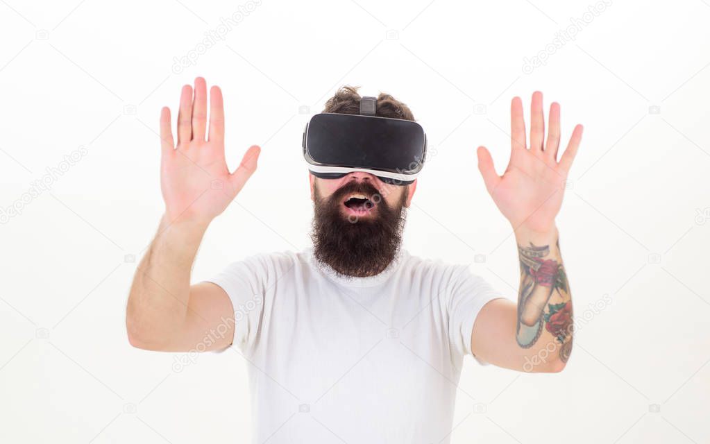 Portrait of bearded male in a white T-shirt with virtual reality glasses on his head isolated on white background. Man wearing virtual reality goggles in white background. Interfaces.