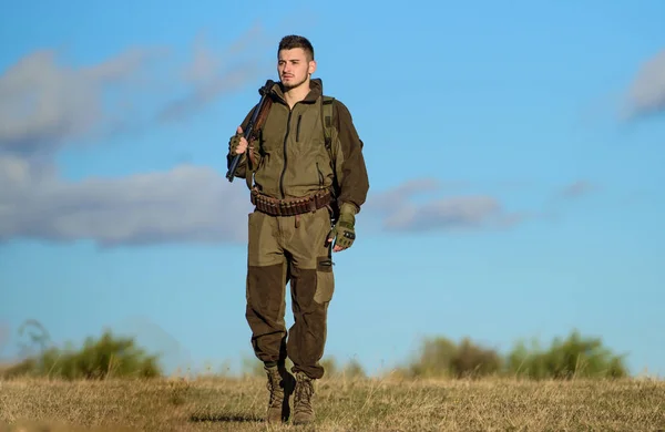 Actividad pasatiempo masculino. Hombre cazador llevar rifle azul cielo fondo. La experiencia y la práctica dan éxito a la caza. Pasatiempo de caza. Un tipo cazando ambiente natural. Pistola o rifle de caza —  Fotos de Stock