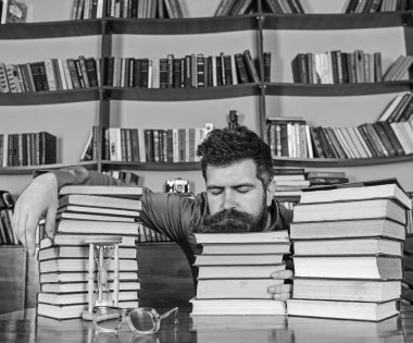 Yüz uyuyan adamın kitap yığınları arasında yatıyordu, kitaplığında, arka plan üzerinde kitap rafı öğrenimleri sırasında uykuya. Overstudied kavramı. Öğretmen ya da öğrenci sakallı defocused kitaplar üzerinde uyuya