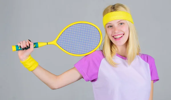 Girl adorable blonde play tennis. Sport for maintaining health. Active leisure and hobby. Athlete hold tennis racket in hand on grey background. Tennis sport and entertainment. Tennis club concept — Stock Photo, Image