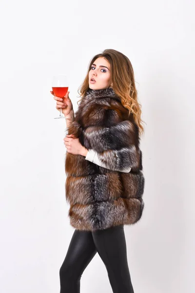 Elite leisure. Lady fashion model curly hairstyle enjoy elite wine. Wine culture concept. Reasons drink red wine in wintertime. Woman drink wine. Girl fashion makeup wear fur coat hold glass alcohol