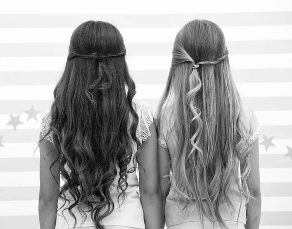 hairdresser salon services. two little girls kids with long hair at hairdresser. little girls with long curly hair. long and healthy hair