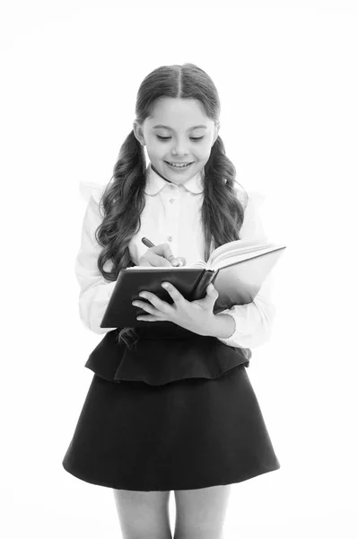 Schoolgirl write daily schedule notepad isolated on white. Little child hold textbook with pen. Plan for week. Home schooling education. Adorable bookworm planning her studying schedule for week — Stock Photo, Image