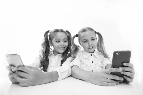 Bloggen op school. weinig gelukkig meisjes bloggen op smartphones. kleine meisjes terug naar school. technologieën maakt het leven makkelijker — Stockfoto