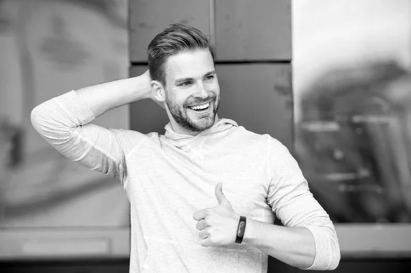 Guy happy emotional approve expression. Approve or recommend concept. Man with brilliant smile unshaven face shows thumb up gesture urban background. Man happy cheerful face support you or recommend