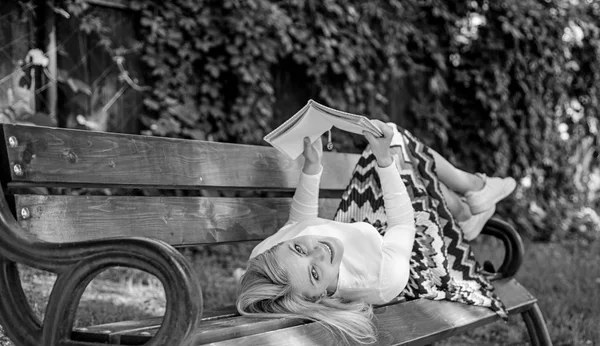 Interesting book. Smart and pretty. Smart lady relaxing. Girl reading outdoors while relaxing on bench. Girl lay bench park relaxing with book, green nature background. Woman spend leisure with book — Stock Photo, Image