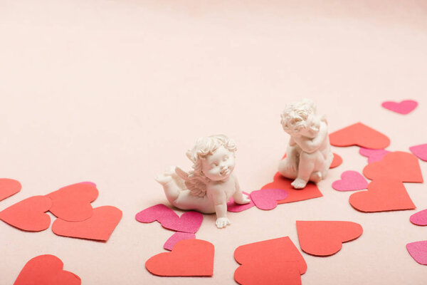 Love and holiday concept: hearts and cupids