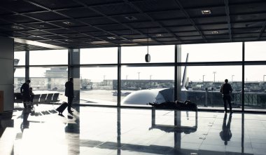 Turizm yolcu çanta, Bagaj lounge salonunda. İnsanlar büyük pencere cam havaalanında uçuş için bekleyin. Yolculuk tutkusu, tatil, seyahat.