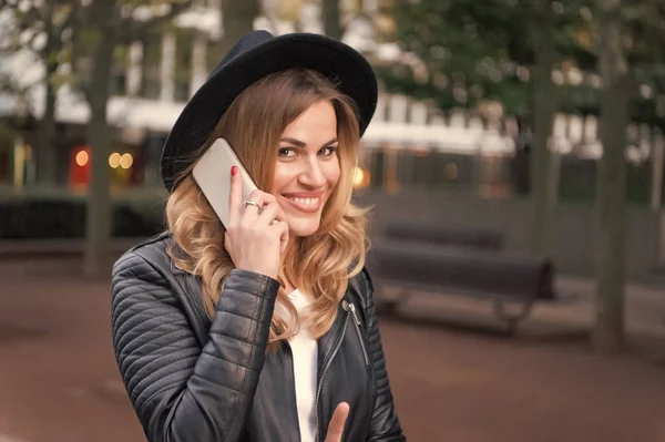 Happy woman talk on mobile phone in paris, france. Sensual woman with long blond hair, hairstyle, beauty. Modern life, new technology, mobile device. Fashion, style, accessory. Beauty, look, makeup