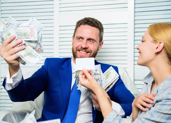 Man business owner sit office pile of money. Bank assistant offer plastic card. Create bank account. Credit loan and cash concept. Businessman with cash bank client. Office manager hold bank card