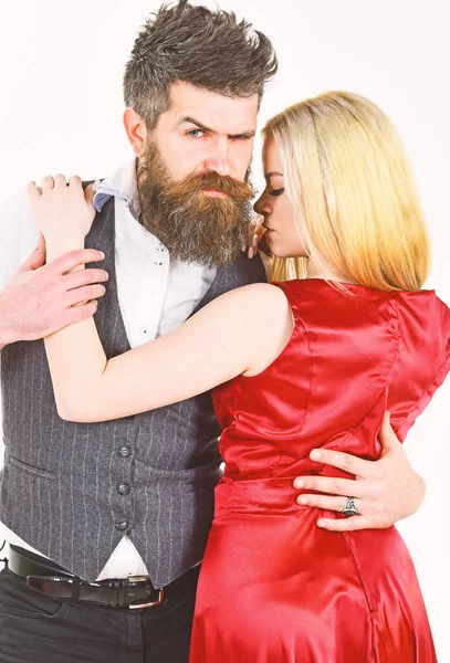 Dancing couple concept. Woman in red dress and man in vest cuddling while dancing. Bearded hipster and attractive lady at dancing contest. Couple in love, dancers in elegant clothes, white background